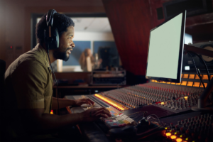 Musician or technology mockup screen in music recording, sound mixing or studio _Producer, happy man with computer headphones for dj radio, audio_images-1200x800